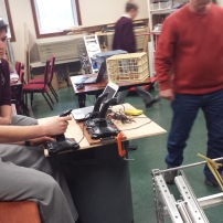 Raymond and Andrew working with mentors on the robot.