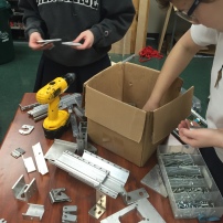 Mebmbers of Build organizing parts for this year's robot